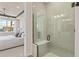 Modern glass shower with a built-in bench and view into the main bedroom at 13551 Pearl Beach St, Winter Garden, FL 34787