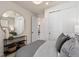 Comfortable bedroom featuring a large round mirror, modern lighting and a sliding door closet at 13551 Pearl Beach St, Winter Garden, FL 34787