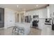 Bright kitchen boasts white cabinets, stainless appliances, marble countertops and backsplash, and a center island with seating at 13551 Pearl Beach St, Winter Garden, FL 34787