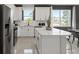Sleek kitchen boasts modern stainless steel appliances, a central island, and ample countertop space at 13551 Pearl Beach St, Winter Garden, FL 34787