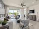 This bright living space with a fan has sliding doors to the back patio and outdoor living, providing modern comfort at 13551 Pearl Beach St, Winter Garden, FL 34787