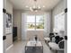 Cozy living room features plenty of natural light, modern lighting, and neutral decor at 13551 Pearl Beach St, Winter Garden, FL 34787