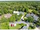 Aerial view of townhouses in a quiet neighborhood with lush, mature trees at 140 Deer Lake Cir, Ormond Beach, FL 32174