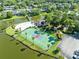 Overhead view of the community pool, tennis court, and landscaping that surround the lakefront recreational area at 140 Deer Lake Cir, Ormond Beach, FL 32174
