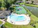 Aerial showcases the community pool and tennis courts, offering recreational opportunities at 140 Deer Lake Cir, Ormond Beach, FL 32174
