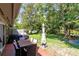 Spacious backyard with patio, dining table, grill and a swing set in the background at 140 Deer Lake Cir, Ormond Beach, FL 32174