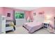 Pink bedroom with two beds and a large window at 140 Deer Lake Cir, Ormond Beach, FL 32174