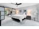 Bright bedroom featuring modern ceiling fan, sliding doors, and decorative plants at 140 Deer Lake Cir, Ormond Beach, FL 32174