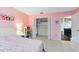 Pink bedroom with closet and an open doorway at 140 Deer Lake Cir, Ormond Beach, FL 32174