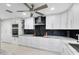 Modern kitchen with white cabinetry, black backsplash, and stainless steel appliances at 140 Deer Lake Cir, Ormond Beach, FL 32174