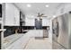 Bright kitchen featuring white cabinets, stainless steel appliances, and modern fixtures at 140 Deer Lake Cir, Ormond Beach, FL 32174