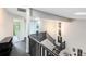 Hallway and staircase with black wood flooring, modern fixtures, and natural light at 140 Deer Lake Cir, Ormond Beach, FL 32174