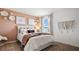 Cozy bedroom featuring a cute accent wall, a bed, a window, and lovely decor at 1495 Fountain View St, Ormond Beach, FL 32174
