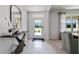 Inviting entryway with light tile flooring, modern console table, and view to the front door at 1495 Fountain View St, Ormond Beach, FL 32174