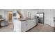 Spacious open kitchen with a center island, stainless appliances, and view of the living area and staircase at 1495 Fountain View St, Ormond Beach, FL 32174