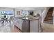 Open-concept kitchen with island, stainless steel appliances, and seamless flow to the dining area at 1495 Fountain View St, Ormond Beach, FL 32174