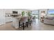 Modern kitchen with granite countertops, stainless steel appliances, and a breakfast bar with seating at 1495 Fountain View St, Ormond Beach, FL 32174