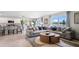 Open living area with a comfortable gray sectional and a view into the kitchen and lake views at 1495 Fountain View St, Ormond Beach, FL 32174