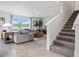 Bright living room with plush gray seating, large window with a water view, and neutral decor at 1495 Fountain View St, Ormond Beach, FL 32174
