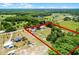 Aerial view of the property showcasing the houses, pool, barn, road and property lines at 1508 Lake Mills Rd, Chuluota, FL 32766