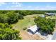 Aerial view of the property showcasing the barn and the surrounding landscape at 1508 Lake Mills Rd, Chuluota, FL 32766