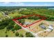 Aerial view of the property showcasing the houses, pool, barn, road and property lines at 1508 Lake Mills Rd, Chuluota, FL 32766