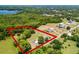 Aerial view of the property showcasing the houses, pool, barn and the surrounding landscape at 1508 Lake Mills Rd, Chuluota, FL 32766