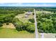 Aerial view showing a large property with a pool and beautiful surrounding greenery at 1508 Lake Mills Rd, Chuluota, FL 32766