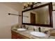 Bathroom featuring a double sink vanity with granite countertop and bronze fixtures at 1508 Lake Mills Rd, Chuluota, FL 32766