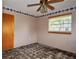 This bedroom shows peeling floors, ceiling fan, wallpaper border, and a window at 1508 Lake Mills Rd, Chuluota, FL 32766