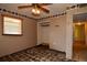 Bedroom shows peeling floors, ceiling fan, closet, window and wallpaper border at 1508 Lake Mills Rd, Chuluota, FL 32766