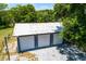 Large garage with multiple bays set amongst a beautiful grove of trees at 1508 Lake Mills Rd, Chuluota, FL 32766