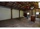 Spacious garage interior featuring a high ceiling, concrete floor and multiple roll-up doors for easy access at 1508 Lake Mills Rd, Chuluota, FL 32766