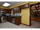 Kitchen featuring stainless steel appliances, wood cabinets, and a view of the living room with fireplace at 1508 Lake Mills Rd, Chuluota, FL 32766