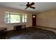 Living room featuring a large window overlooking the front yard and a red door at 1508 Lake Mills Rd, Chuluota, FL 32766