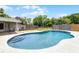 Inviting kidney-shaped pool with sun deck and fenced in yard for your enjoyment at 1508 Lake Mills Rd, Chuluota, FL 32766