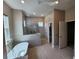 Modern bathroom featuring a luxurious soaking tub and a sleek glass-enclosed shower at 160 Steeplechase Cir, Sanford, FL 32771