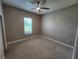 Simple bedroom design with carpet, a ceiling fan, and a view from the window at 160 Steeplechase Cir, Sanford, FL 32771