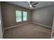 Cozy bedroom featuring neutral walls, plush carpeting, ceiling fan, and a bright window at 160 Steeplechase Cir, Sanford, FL 32771