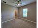 Light neutral bedroom features plush carpet, ceiling fan, and a scenic view through a window at 160 Steeplechase Cir, Sanford, FL 32771