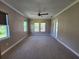 Spacious bedroom with a ceiling fan, large windows, and access to the backyard at 160 Steeplechase Cir, Sanford, FL 32771