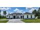 Beautiful single-story home featuring a stone facade, manicured lawn, and attached two-car garage at 160 Steeplechase Cir, Sanford, FL 32771