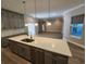 Modern kitchen with a white countertop island, hardwood floors, and grey cabinets at 160 Steeplechase Cir, Sanford, FL 32771