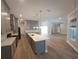 Modern kitchen featuring grey cabinets, stainless appliances, an island, and hardwood floors at 160 Steeplechase Cir, Sanford, FL 32771