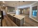 Spacious kitchen with island, stainless appliances, hardwood floors, and grey cabinets at 160 Steeplechase Cir, Sanford, FL 32771