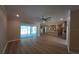 Open-concept living area featuring wood flooring, a ceiling fan, and access to the kitchen at 160 Steeplechase Cir, Sanford, FL 32771