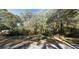 Street view of the wooded property, featuring lush greenery providing a private and serene atmosphere at 160 Steeplechase Cir, Sanford, FL 32771