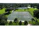 Aerial view of basketball and tennis courts with a community building by a lake at 1716 Wild Indigo Ter, Oviedo, FL 32766