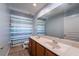 Bathroom with double sink vanity and a shower with patterned curtain at 1716 Wild Indigo Ter, Oviedo, FL 32766