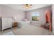 Cozy bedroom with pink walls, a day bed and natural light from the window at 1716 Wild Indigo Ter, Oviedo, FL 32766